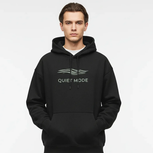 Person wearing a black hoodie with 'Quiet Mode' text on a white background